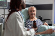 © DC Studio - Close up of sick unwell senior man patient laying in hospital bed. listening doctor specialist discussing about treatment holding pills bottle reassuring full recovery. Man breathing with help from