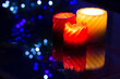 Beautiful aromatic candles with blue bokeh lights on the background