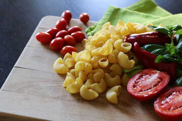 Sticker - Fresh ingredients of making a conchiglie pasta in the kitchen, cherry tomatoes and bell peppers