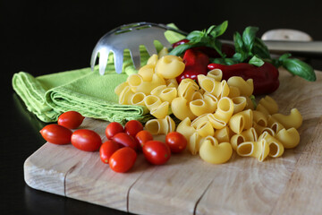 Poster - Fresh ingredients of making a conchiglie pasta on a wooden board