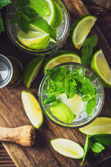 Wall Mural - Refreshing Mojito with Ice Mint and Lime on Woodden Table