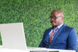 © xartproduction - portrait of afroamerican businessman in a business suit sitting at a table in a meeting