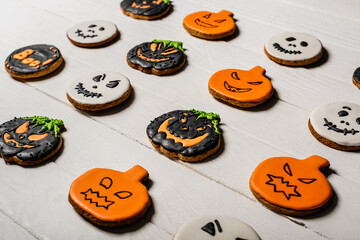 Wall Mural - sweet and spooky pumpkin shape halloween cookies on white surface
