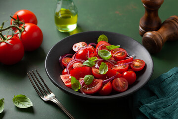 Wall Mural - healthy tomato salad with onion basil olive oil and balsamic vinegar