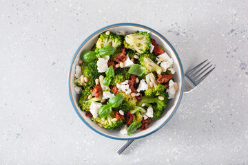 Wall Mural - healthy broccoli salad with feta cheese sun dried tomatoes pine nuts.. vegetarian low carb keto diet