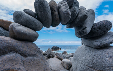 Sticker - Closeup shot of stone on the beach on a clear sky background