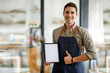 © David - Portrait of Starting small handsome man businesses owners showing tablet with blank screen at coffee shop.