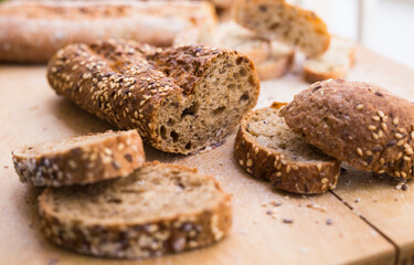 Wall Mural - fresh loaf of bread on wooden board