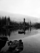 Grayscale Photo Of Lake Surrounded By Trees In Snoqualmie Pass, Washington, United States