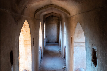 Wall Mural - An arched arcaded corridor in the ancient Raja Mahal palace in Orchha.