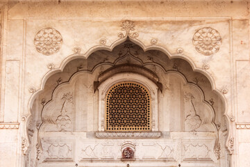 Sticker - Marble arches and a lattice window on the weathered walls of the ancient City Palace in the city of Jaipur in Rajasthan, India.