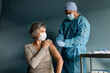 © McKinsey Jordan/Stocksy - Nurse Puts a Bandage on a Senior Woman's Arm