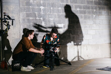 Cinematographer And Director Filming In A Parking Garage