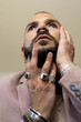 © Eloisa Ramos/Stocksy - Portrait of modern man with jewelry