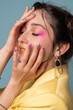 © Julie Meme/Stocksy - Closeup portrait with fancy nail art
