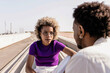 © Guille Faingold/Stocksy - Black woman talking to man.