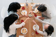 © Studio Marmellata/Stocksy - Asian friends drinking sake at home