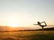 © Miquel Llonch/Stocksy - Woman practicing Lord of the Dance in mountains at dawn