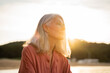 © Alba Vitta/Stocksy - Beautiful pensive mature woman relaxing at beach