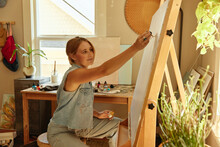 Woman Painting In A Home Studio. 