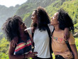 © David Prado/Stocksy - black ethnic afro sisters looking at camera while hiking
