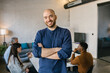 © Mihajlo Ckovric/Stocksy - Portrait of a cheerful young businessman in the office