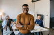 © Mihajlo Ckovric/Stocksy - Portrait of a cheerful young businessman in the office