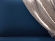 © Miquel Llonch/Stocksy - Soft gray blanket on blue couch back