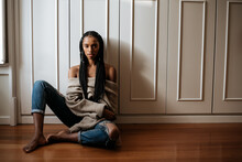 Beautiful Black Woman With Braided Long Hair Sitting In The Floor