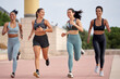 © Guille Faingold/Stocksy - Happy diverse female joggers running in park