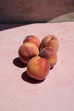 Fresh Peaches On A Pink Marble Background