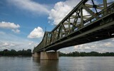 Fototapeta Most - railroad bridge across the Danube river in Vienna on a sunny cloud sky day