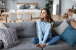 © BestForYou - Cute smiling woman on the couch in a cozy interior