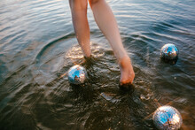 Feet In The Sea With Mirror Balls