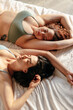 © Marc Bordons/Stocksy - Two young women lying on the bed