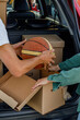 © Danil Nevsky/Stocksy - Crop couple packing basketball ball in car