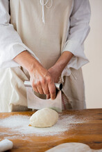 Woman Kneading Dough To Make Bagels