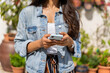 © Alba Vitta/Stocksy - Closeup of woman's hands holding phone outdoors
