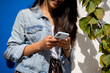 © Alba Vitta/Stocksy - Closeup of woman's hands holding phone outdoors