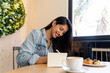 © Alba Vitta/Stocksy - Young woman writing notes while coffe break