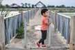© Chalit Saphaphak/Stocksy - Boy on the bridge