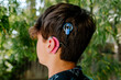 © Erin Brant/Stocksy - Close up of teen boy with Cochlear implants