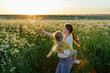 © Sergey Narevskih/Stocksy - Mother and daughter blowing bubbles in meadow