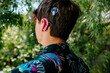 © Erin Brant/Stocksy - Close up of teenager with Cochlear implants