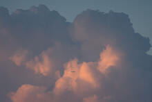 Airplane In Huge Clouds
