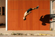 © Javier Díez/Stocksy - Agile sportsman doing back jump trick on street