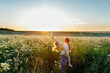 © Sergey Narevskih/Stocksy - Joyful mother blowing soap bubbles with happy kid
