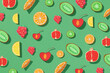 Mix of different fruits and berries isolated on green background