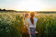 © Sergey Narevskih/Stocksy - Unrecognizable mother and daughter having fun in field