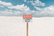 Warning Sign On A Summer Beach